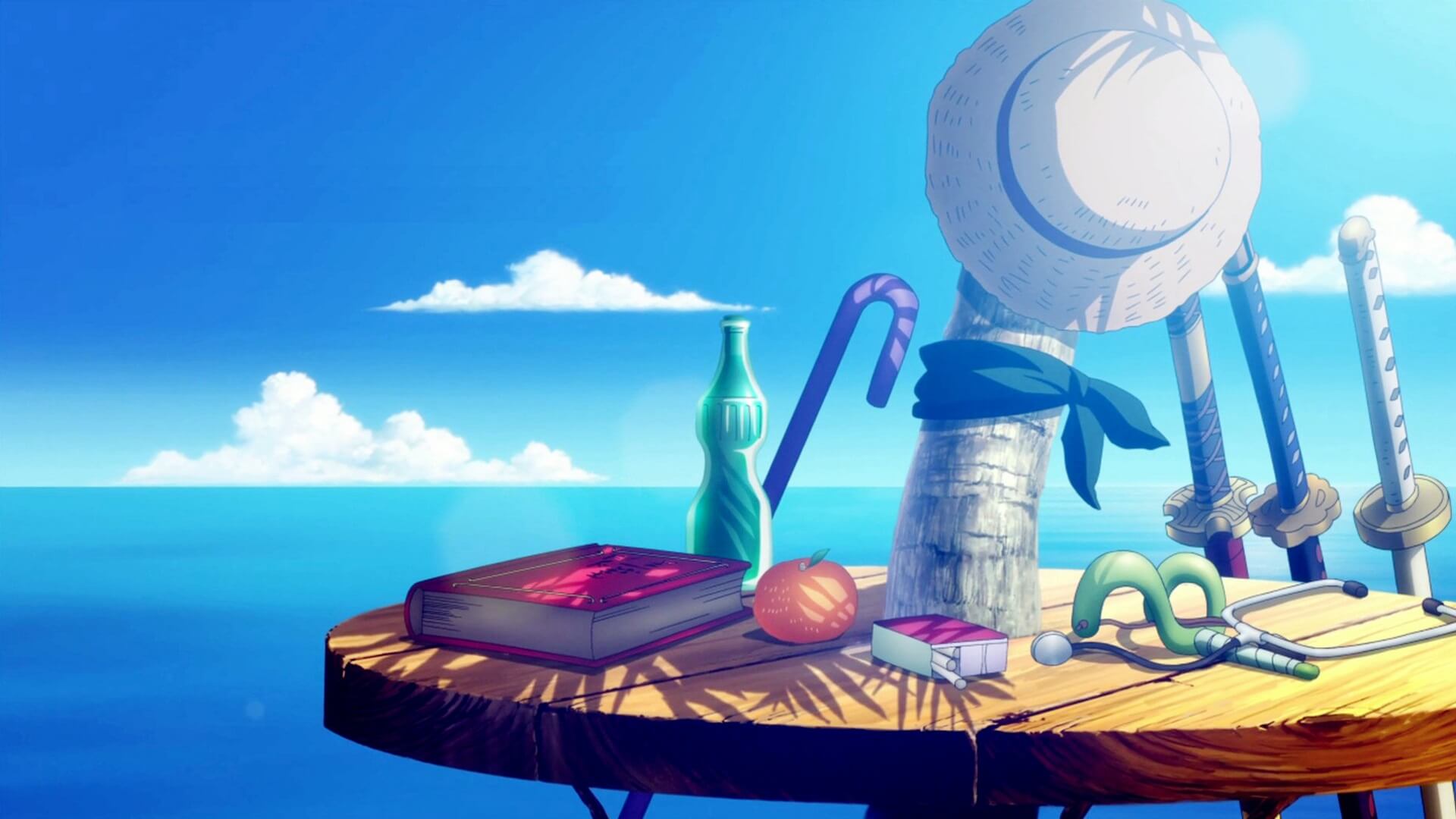 Mesa veraniega con varios objetos y un sombrero de Luffy haciendo homenaje